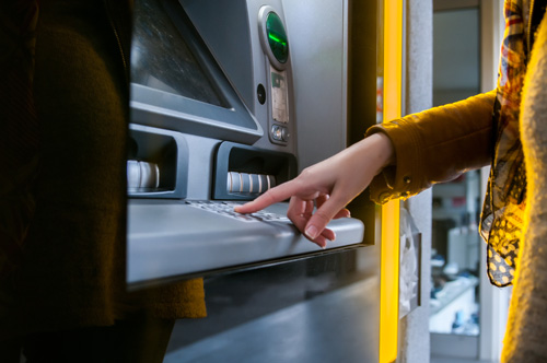 Technician servicing an ATM